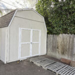 Shed in Concord, CA. Exterior paint by Paintmasters. Color: Sherwin Williams Sandbar SW7547 / Trim in Spare White