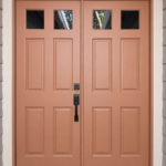 Paintmasters refinished these double entry doors in a custom warm terracotta tone.