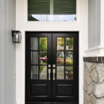 Paintmasters refinished these double entry doors in a sleek black finish, creating a crisp, elegant contrast with the white trim.