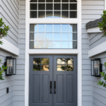 Paintmasters refinished these double entry doors in a sophisticated charcoal gray, creating a clean, modern contrast with the white trim.