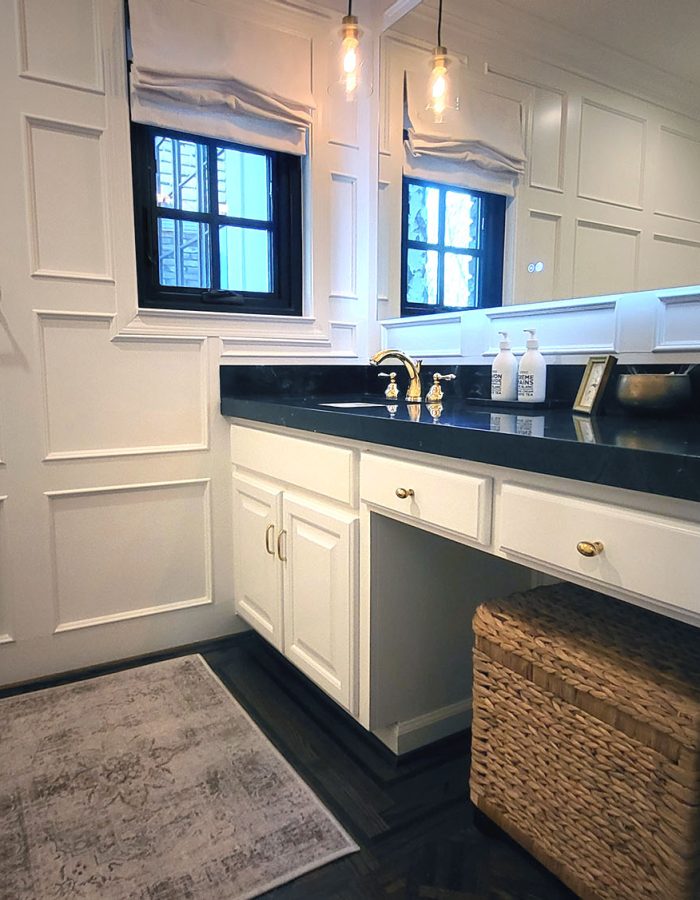 Fresh white bathroom cabinets with dark trim